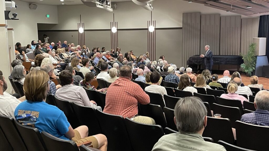 Speaker delivering presentation to crowd