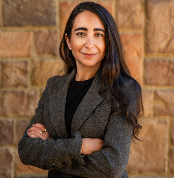 Woman wearing grey blazer smiling posed for photo