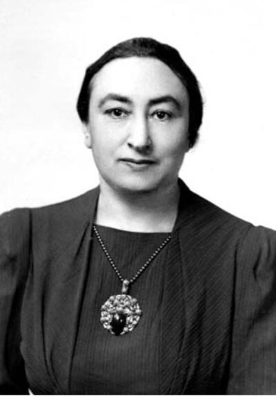 Regina Freibaum Nathan photo wearing dress and large necklace